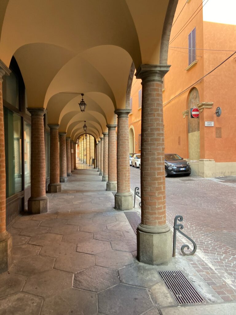Historic porticoes in Bologna, Italy, stretching along the city streets