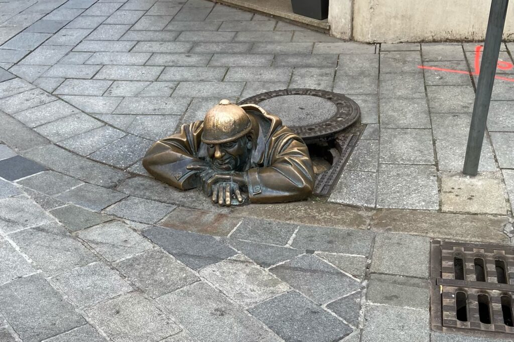Čumil statue in the historic center of Bratislava, Slovakia