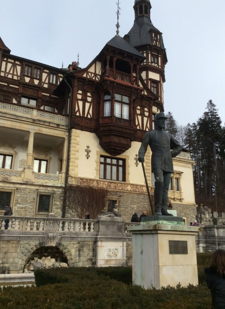 Statue of King Carol I in front of Peleș Castle in Romania