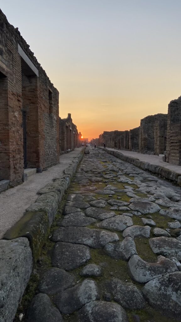 Ruins of ancient Pompeii glowing in the sunset light